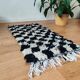 Small Berber rug with black tiles.