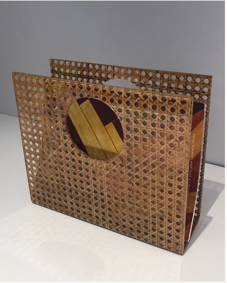 Acrylic magazine rack with inlaid cane.