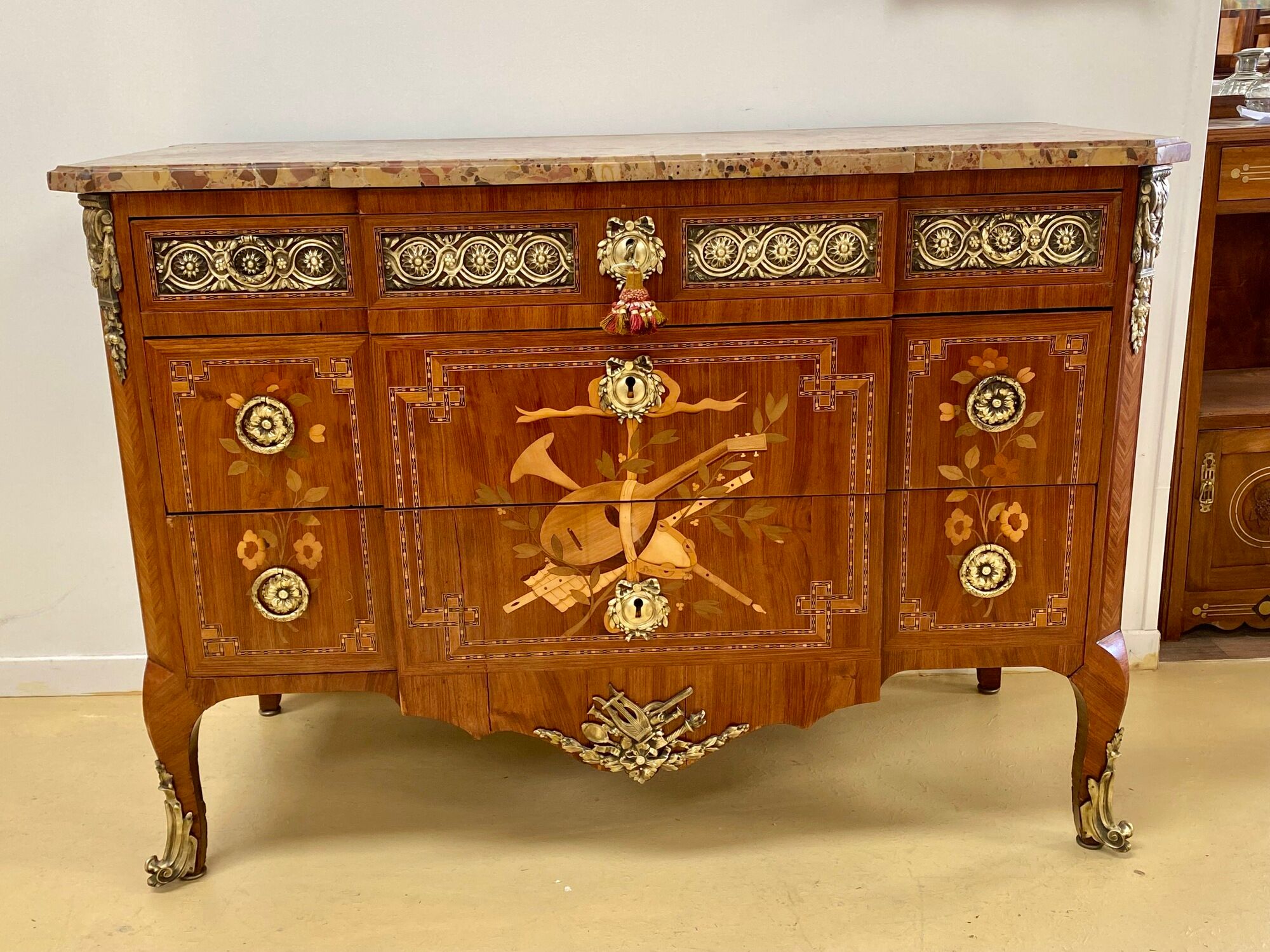 Transition chest of drawers with floral marquetry and music trophy