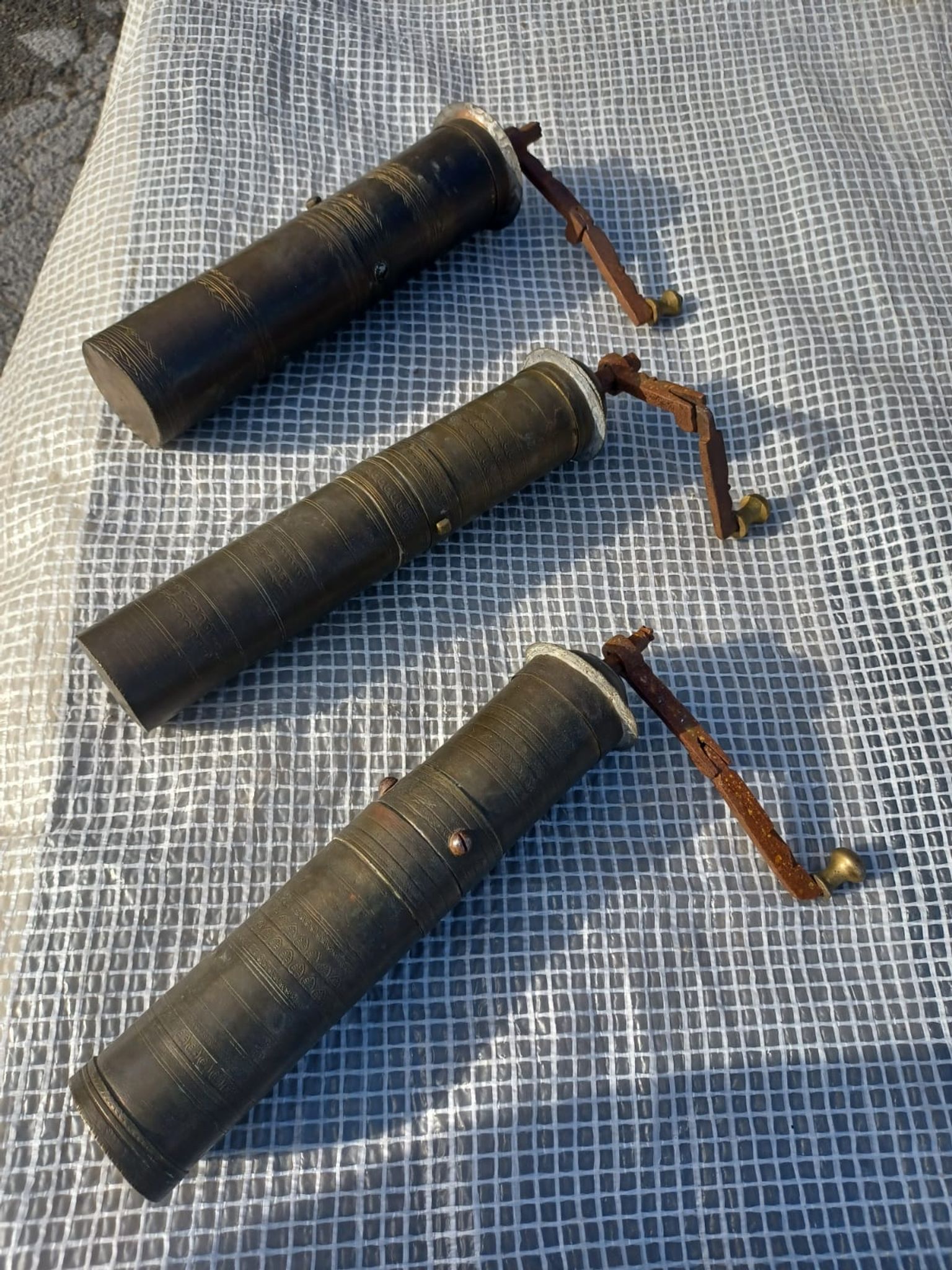 Three oriental brass and iron pepper mills XIX century