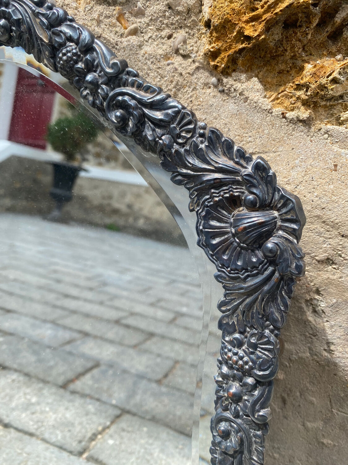 Old mirror carved in gray metal