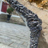 Old mirror carved in gray metal