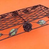 Rectangular metal serving tray with floral decoration.