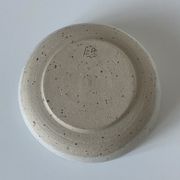 Meeting of three artist's ceramic objects including two pots and a cream covered bowl