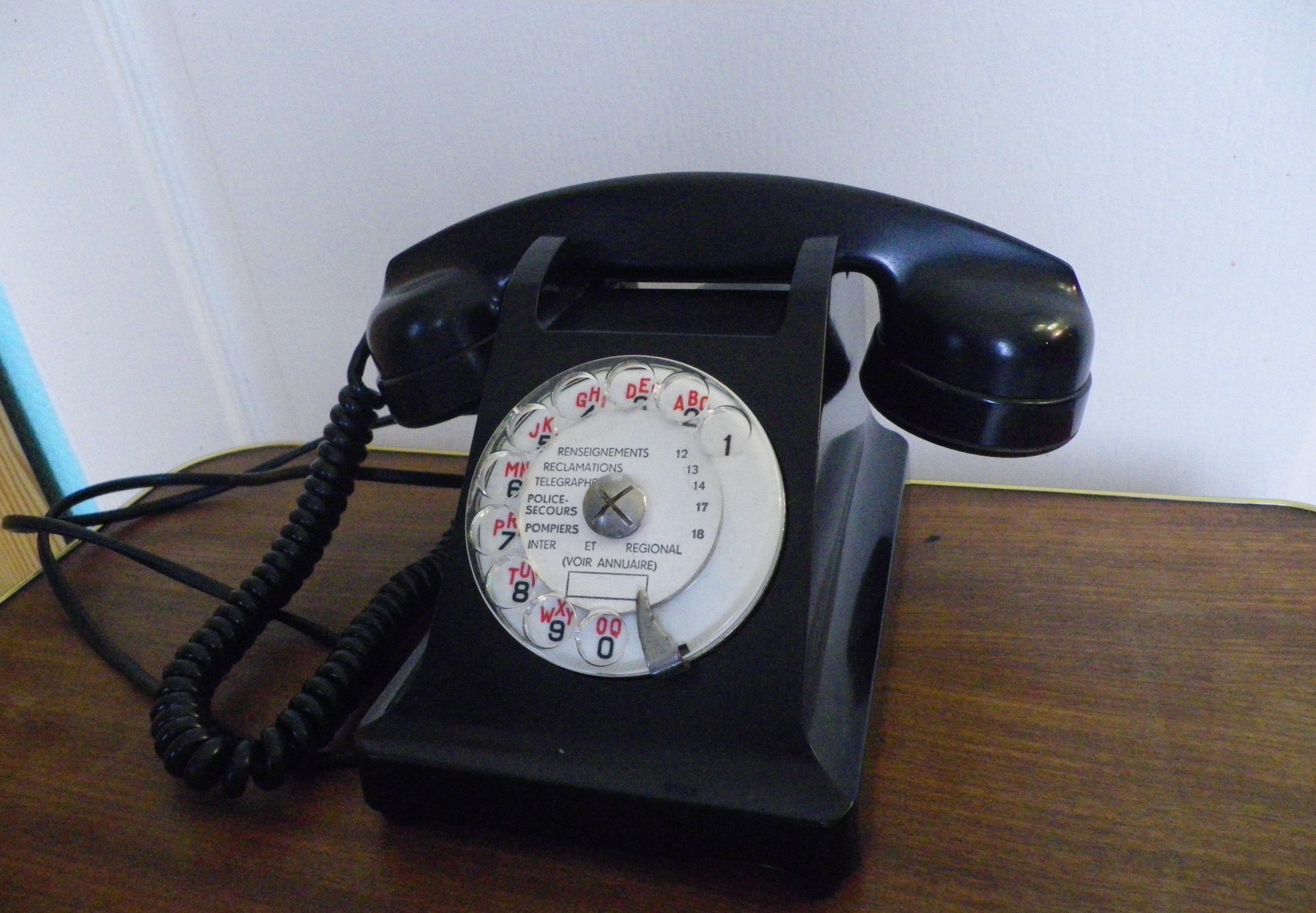 Black bakelite phone with earphone