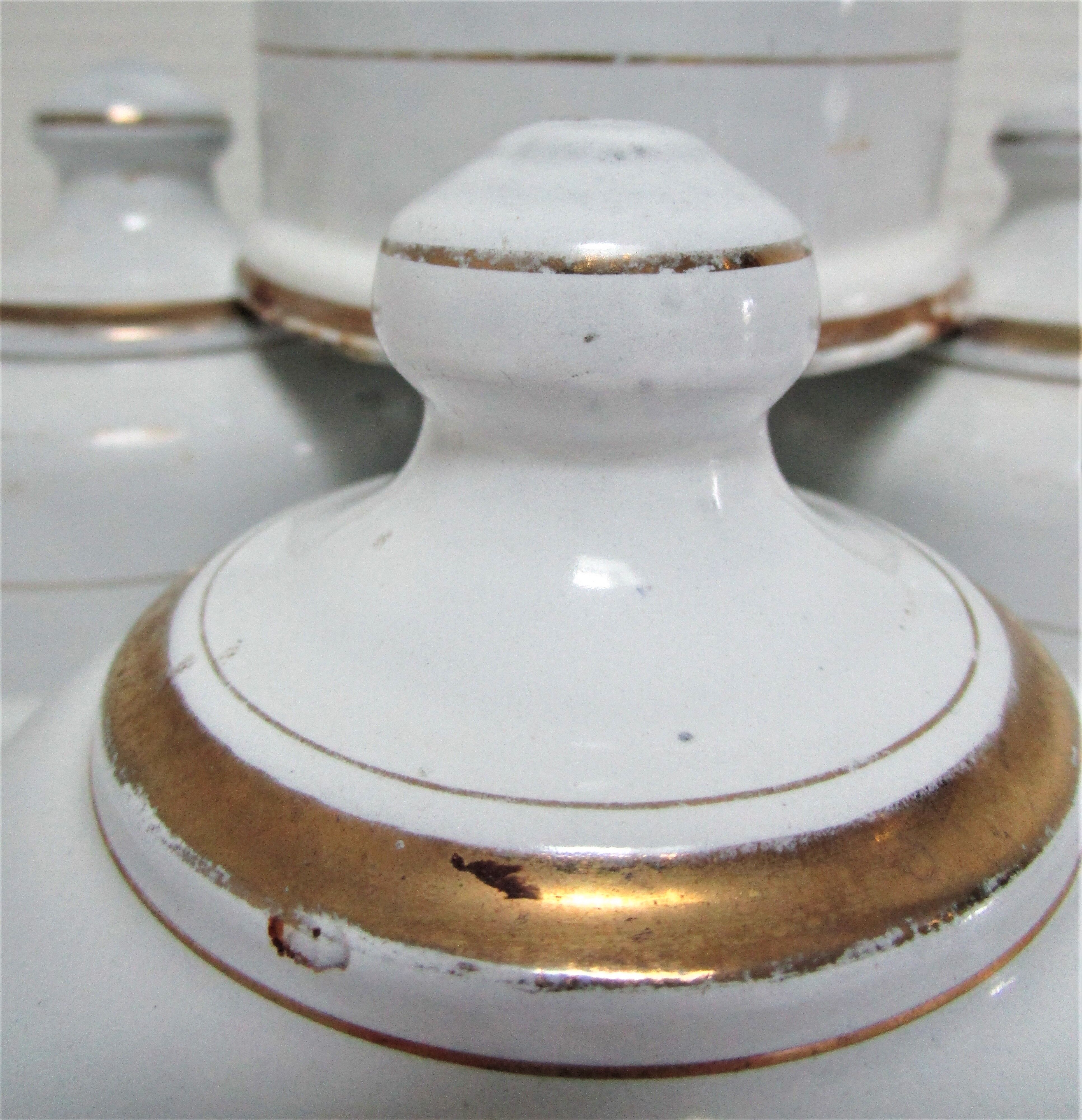 Four white enamelled metal cheese bells early twentieth century