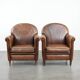 Set of 2 vintage sheepskin armchairs with a characterful appearance