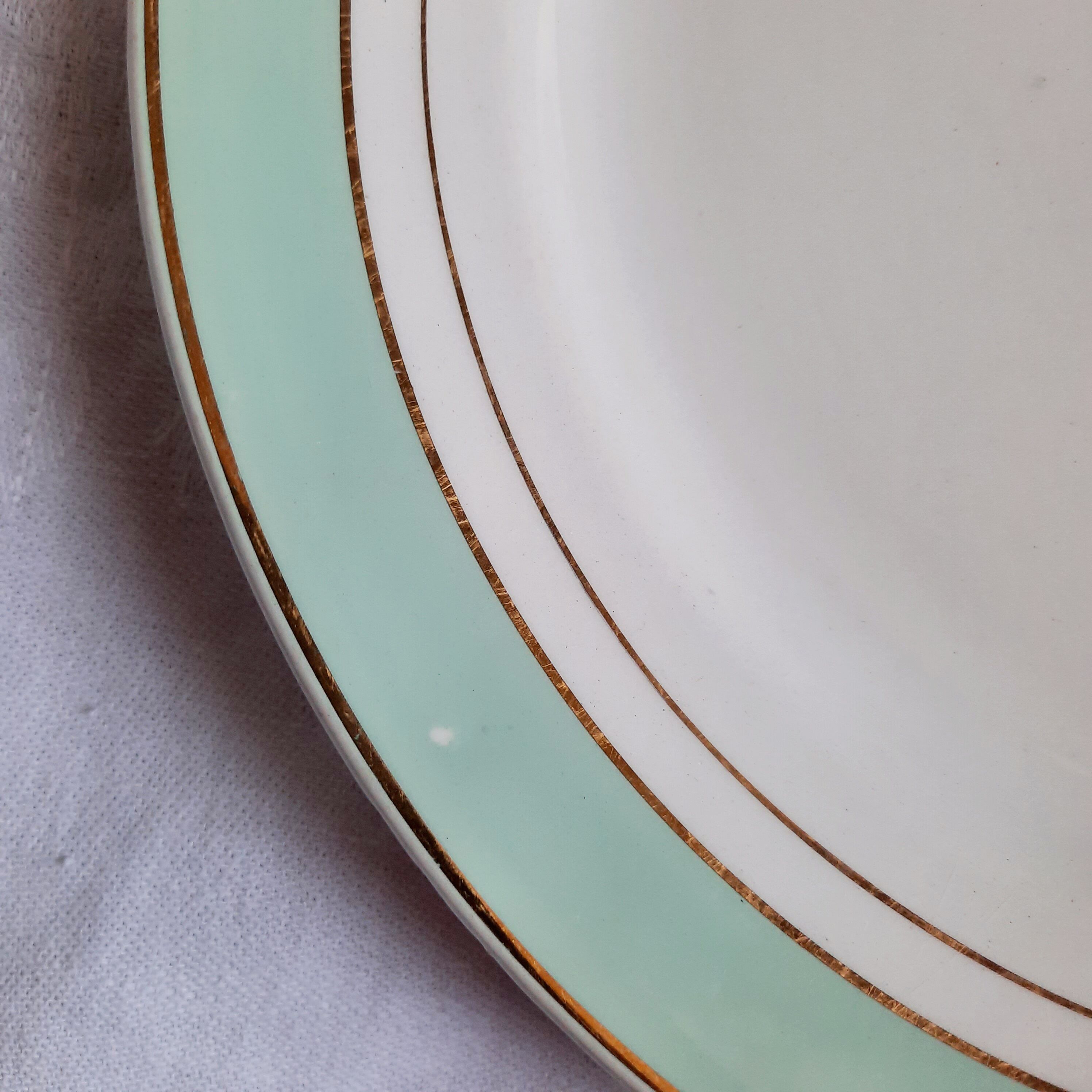 Flat antique earthenware plates with gilded edges