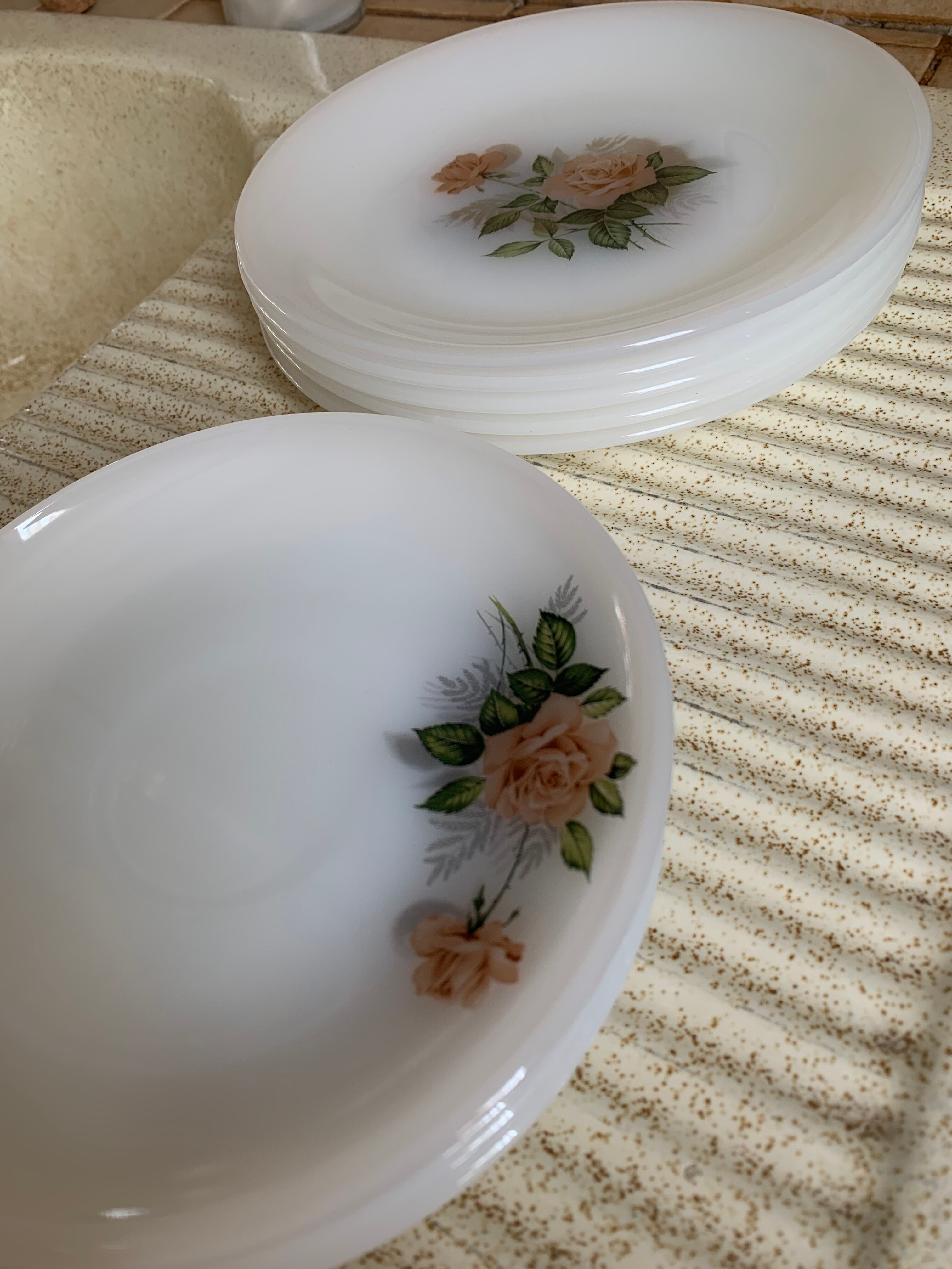 Lots of vintage plates in arcopal floral pattern