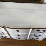 Patinated crossbow chest of drawers.
