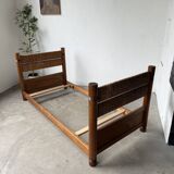 Brutalist style bed with chain and straw