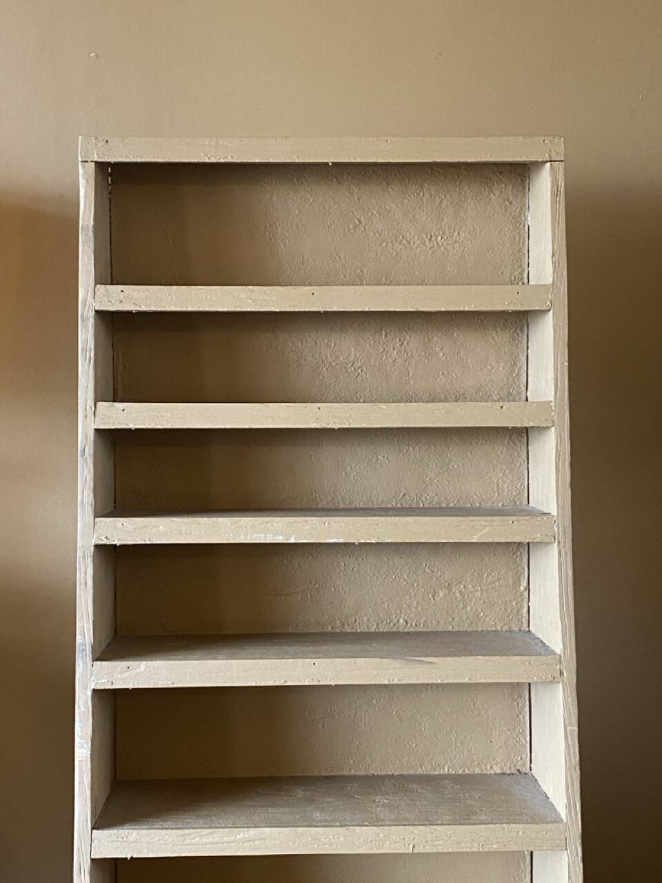 Painted wooden display shelf with an incline