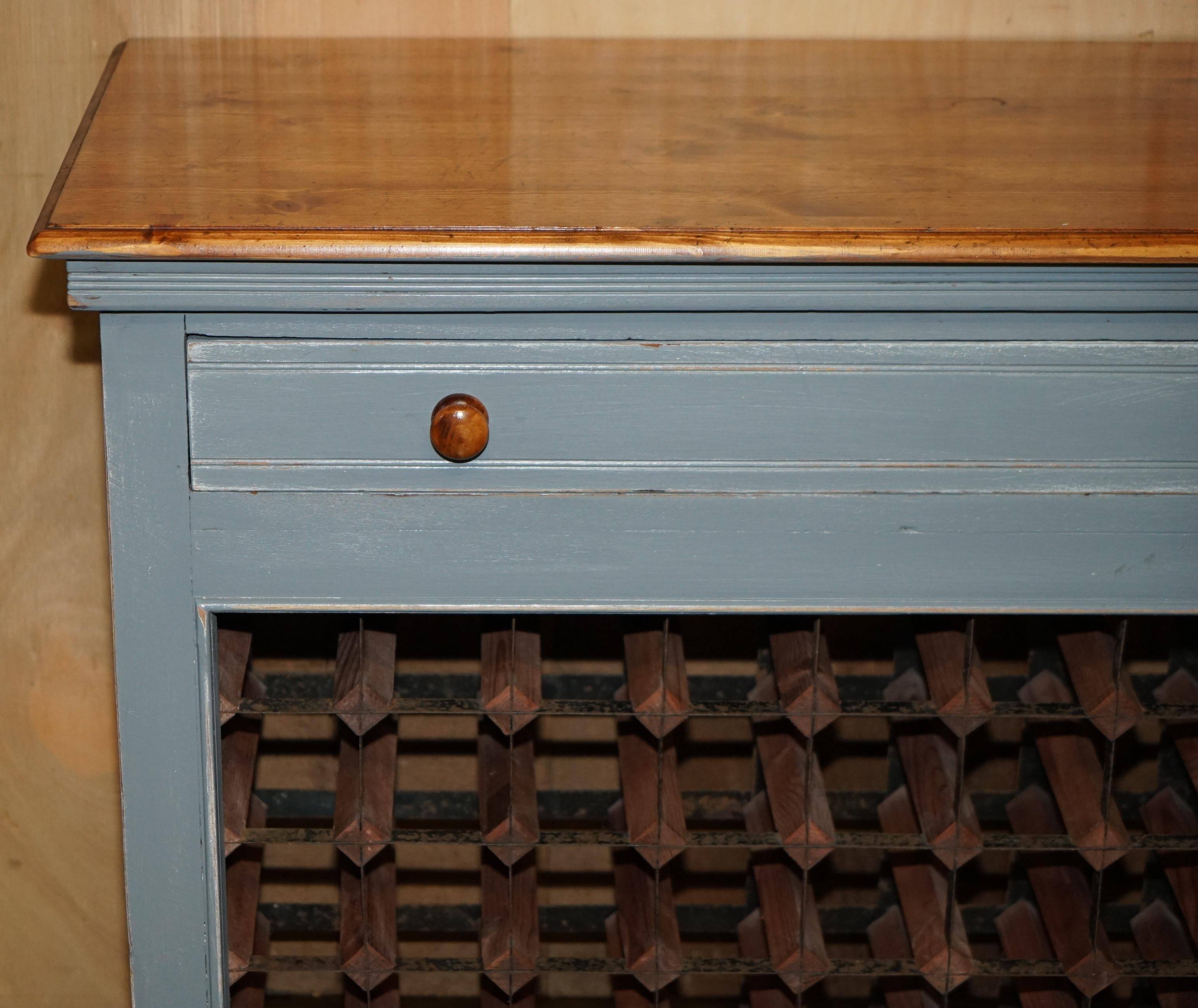 Vintage wooden furniture for 45 wine bottles with a drawer.