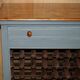 Vintage wooden furniture for 45 wine bottles with a drawer.