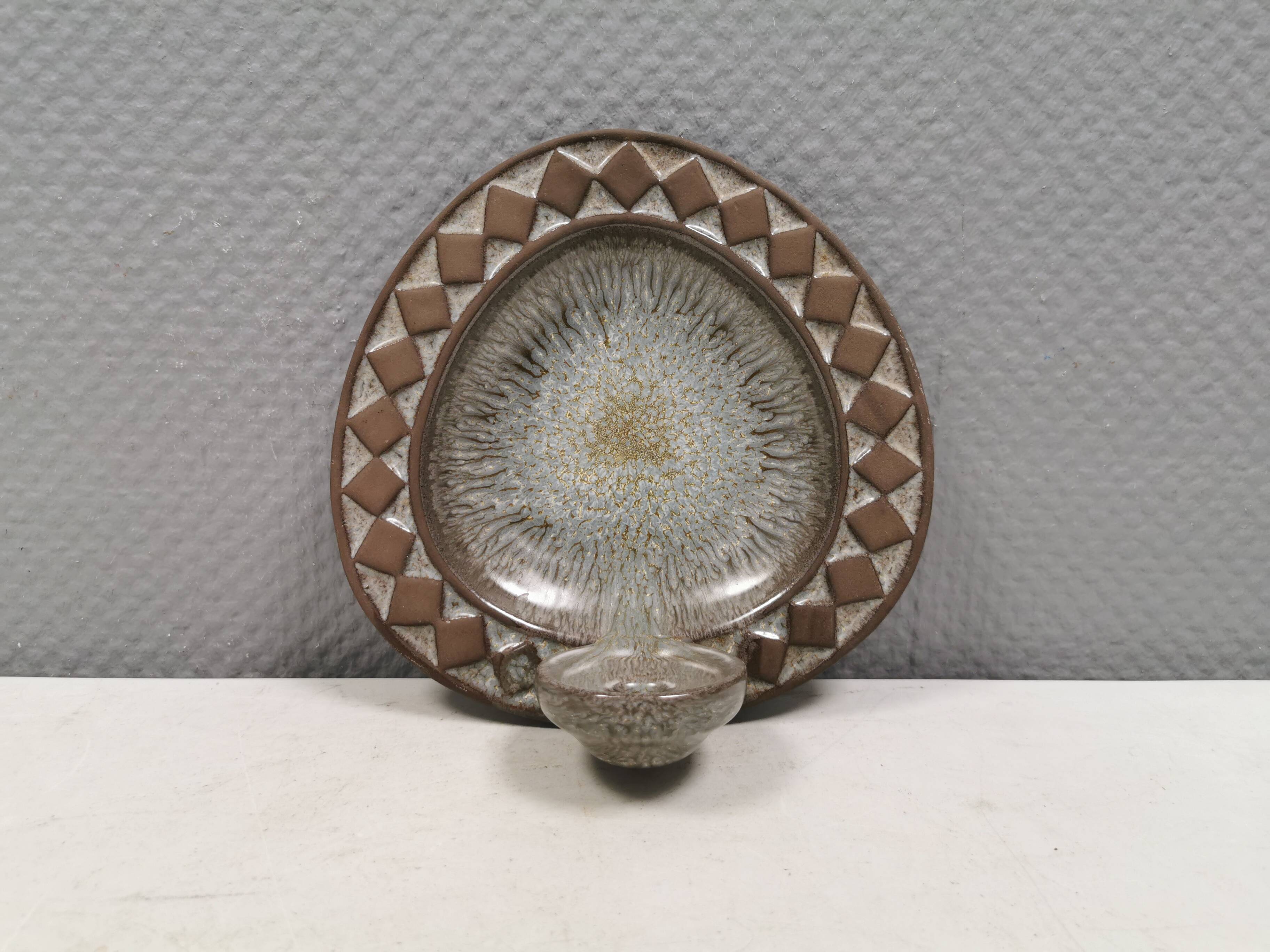 Wall-mounted candlestick in grayish colors, Danish and from the 1970s-80s.