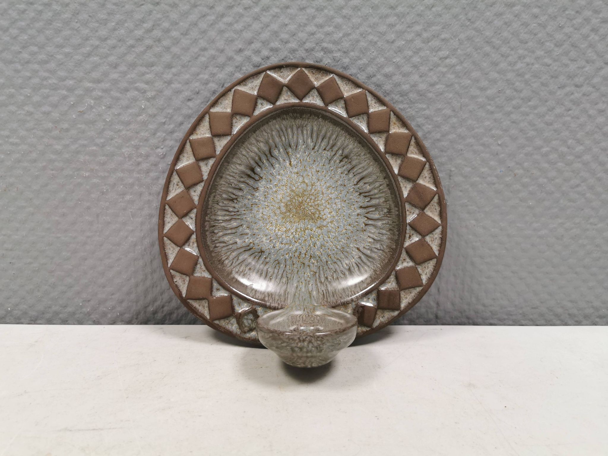 Wall-mounted candlestick in grayish colors, Danish and from the 1970s-80s.