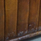 Cognac-colored cowhide 2-seater designer sofa finished with piping
