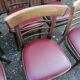 Set of 19 vintage wooden bistro chairs with red faux leather.
