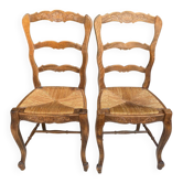 2 Provençal chairs in carved wood with straw seats.