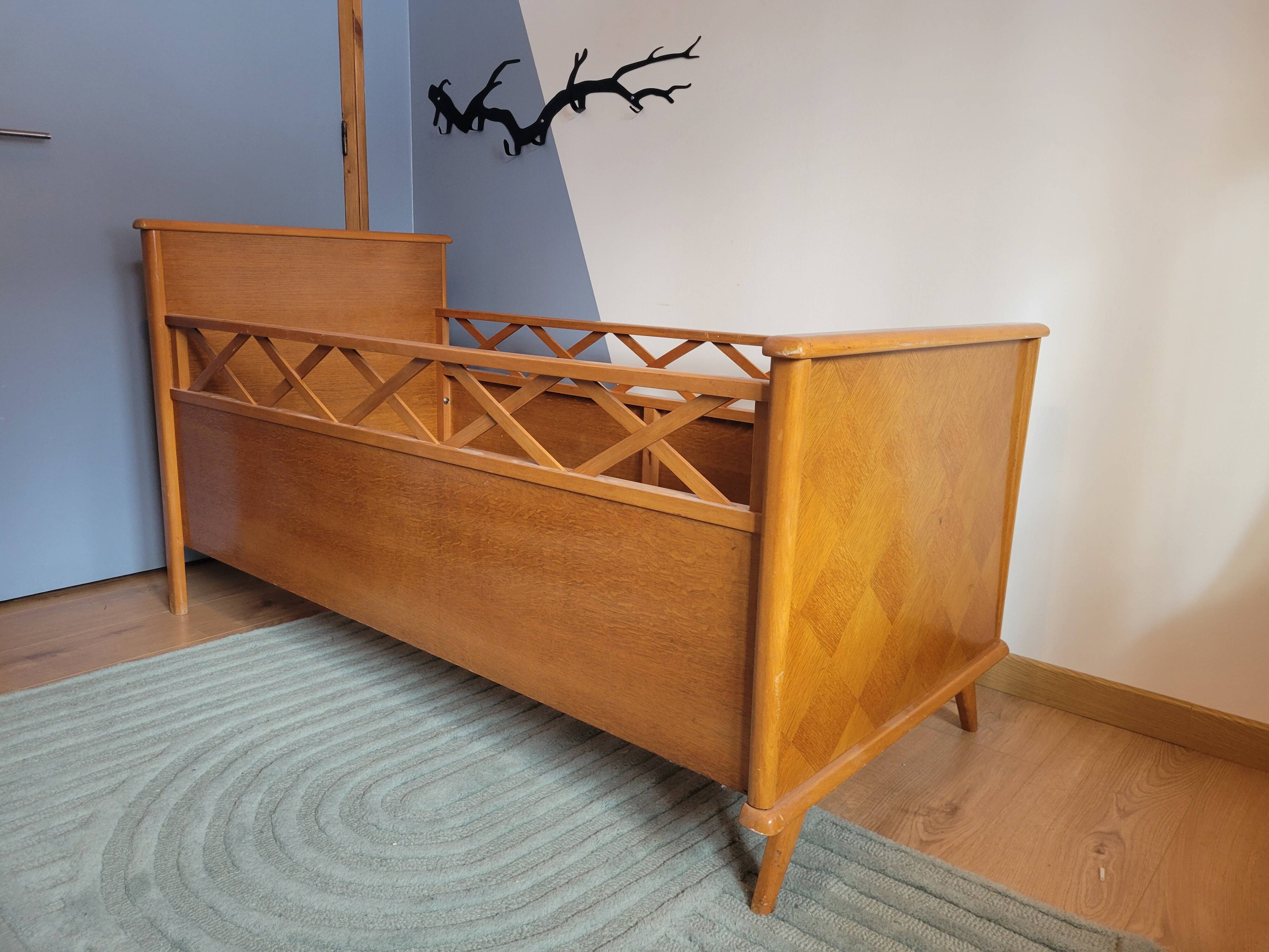 Vintage baby cot with splayed legs.