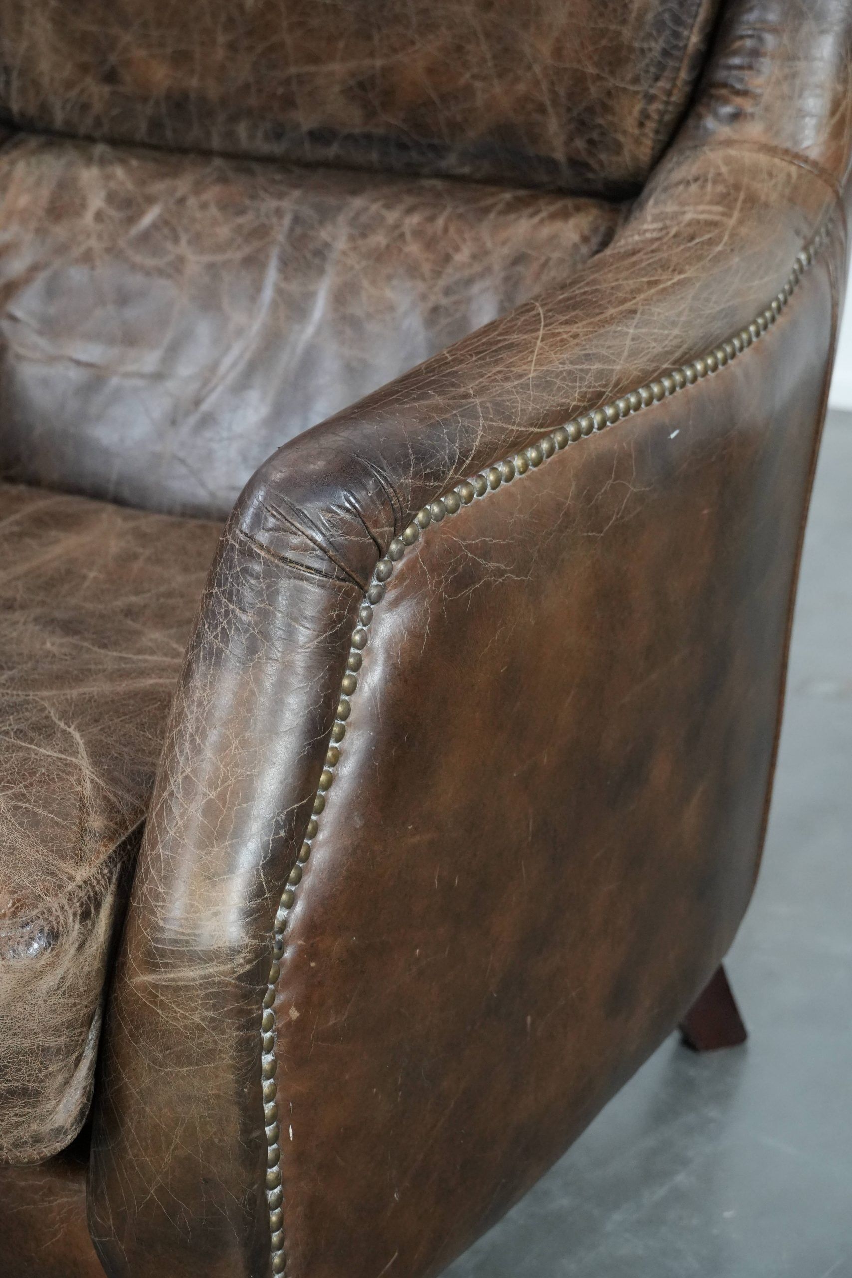Very comfortable vintage cow leather armchair with character