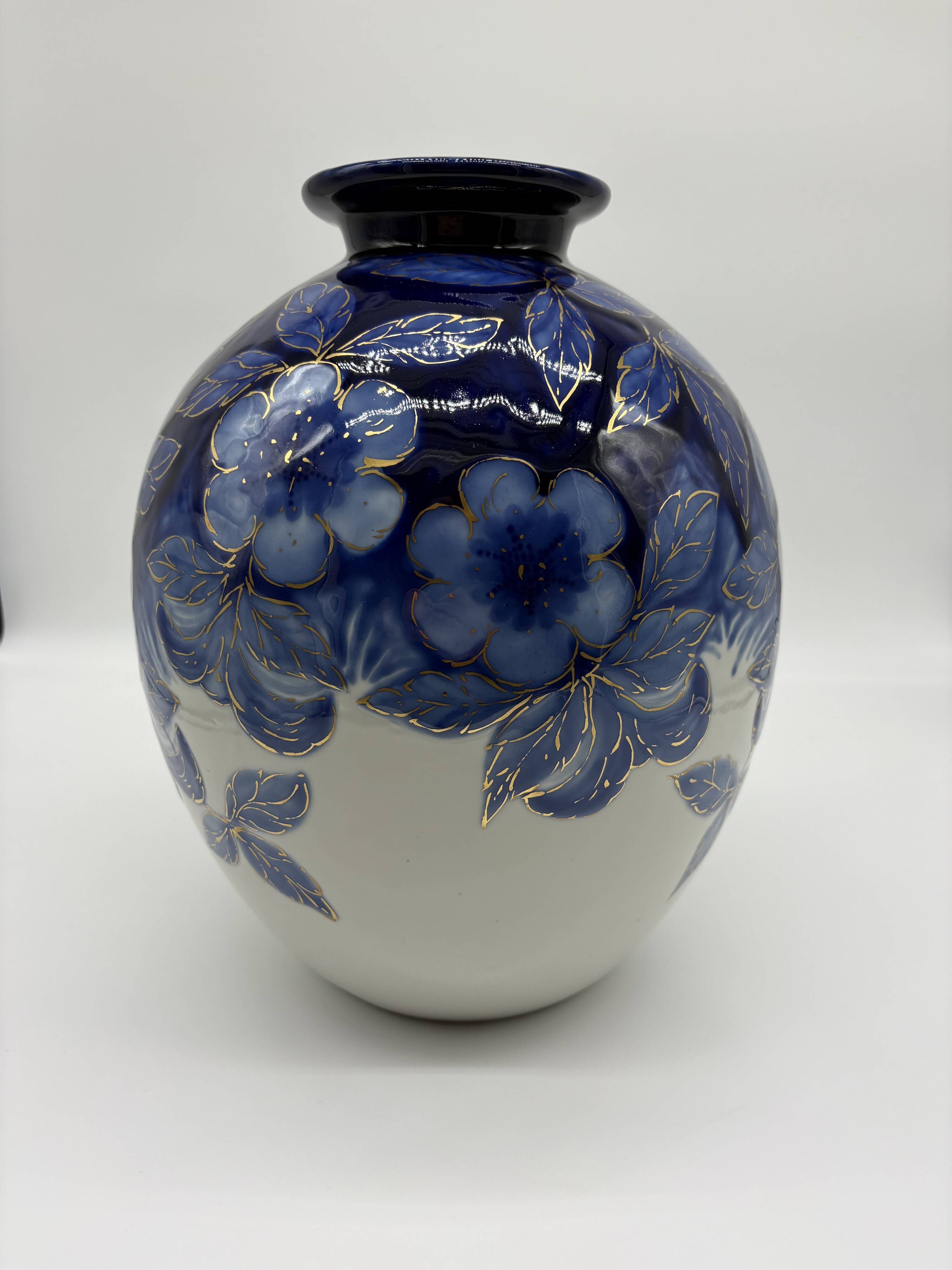 Large Tharaud Limoges vase in cobalt blue porcelain with floral decoration.