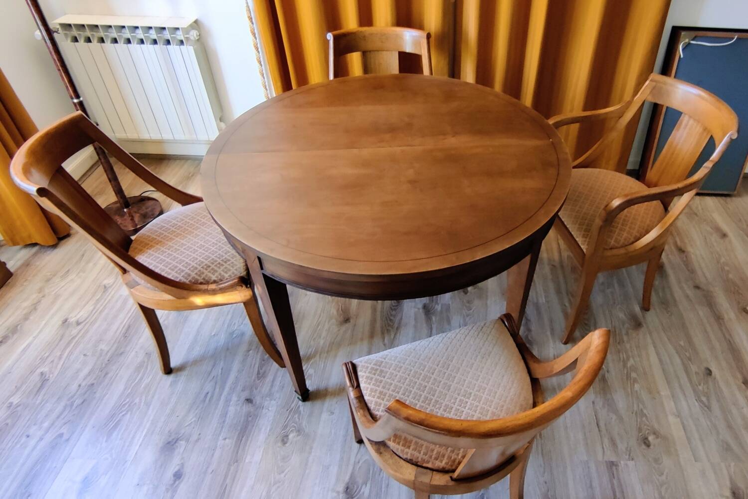 Round cherry table with extension, 3 chairs and 1 armchair.