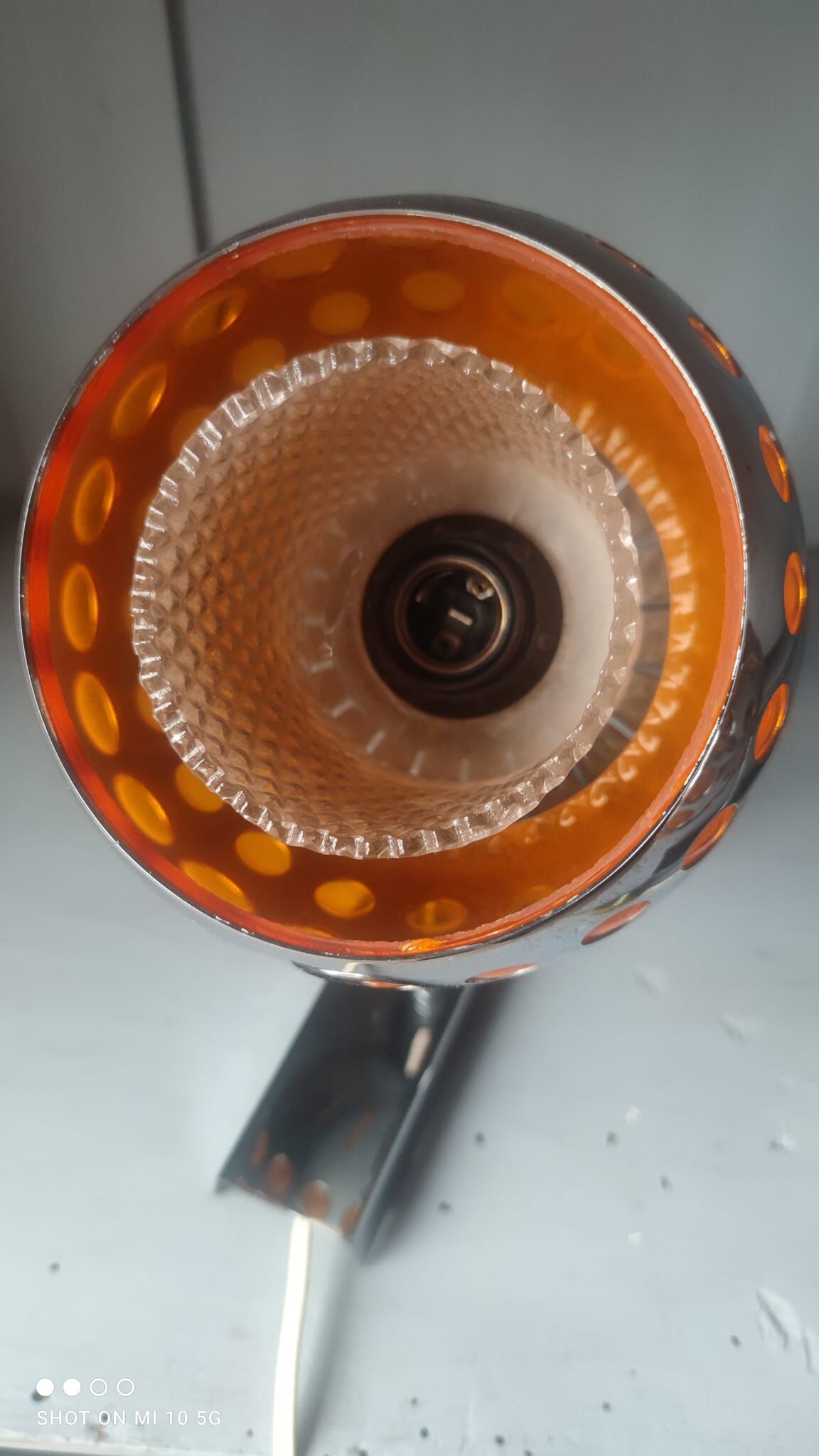 Pair of chrome-plated metal wall lights with adjustable ball joints, circa 1970