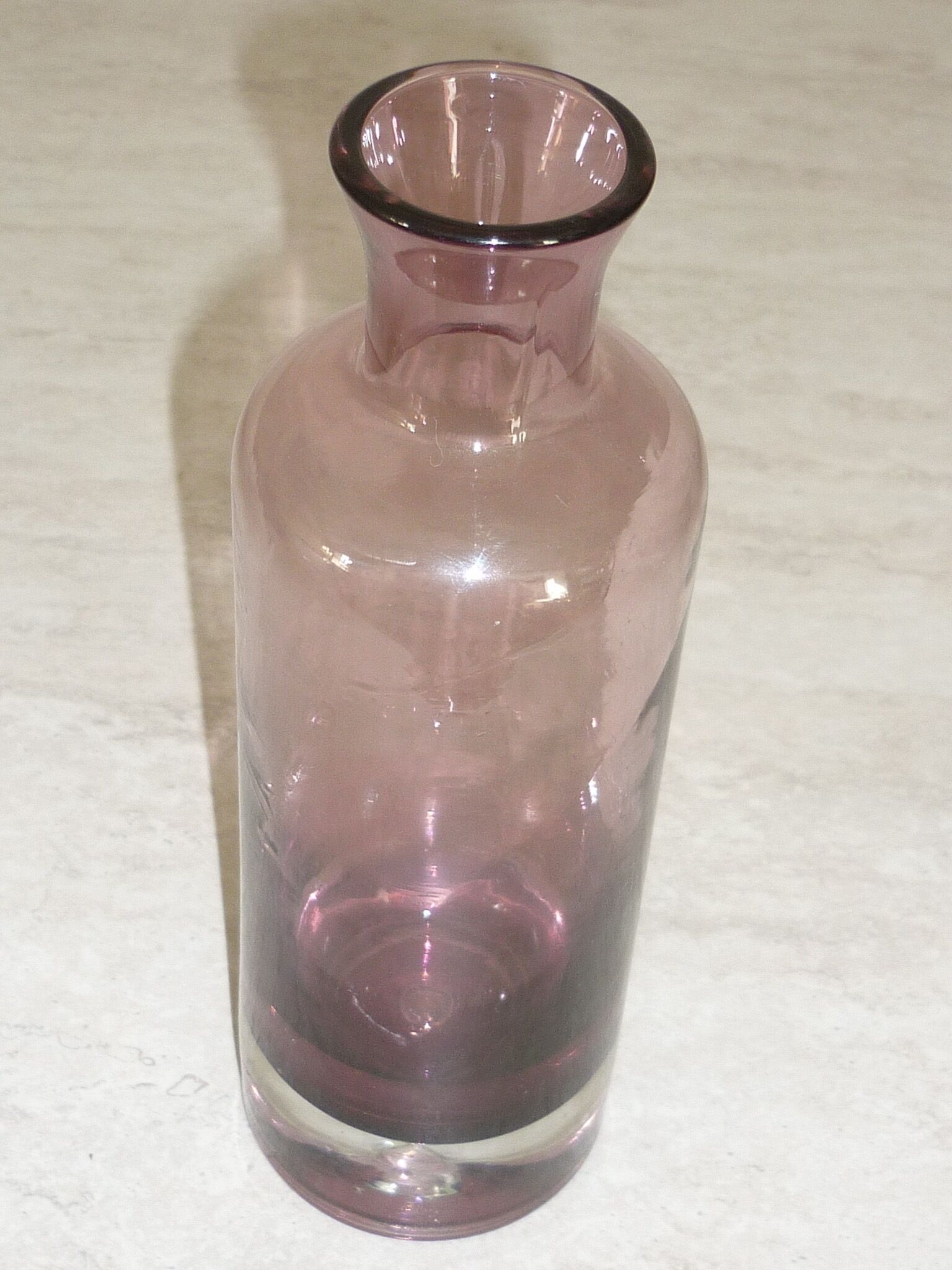 Plum-colored glass bottle with bubble