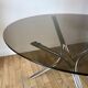 Set consisting of a table in chrome and smoked glass and its 4 tubular chairs in chrome and skaï a