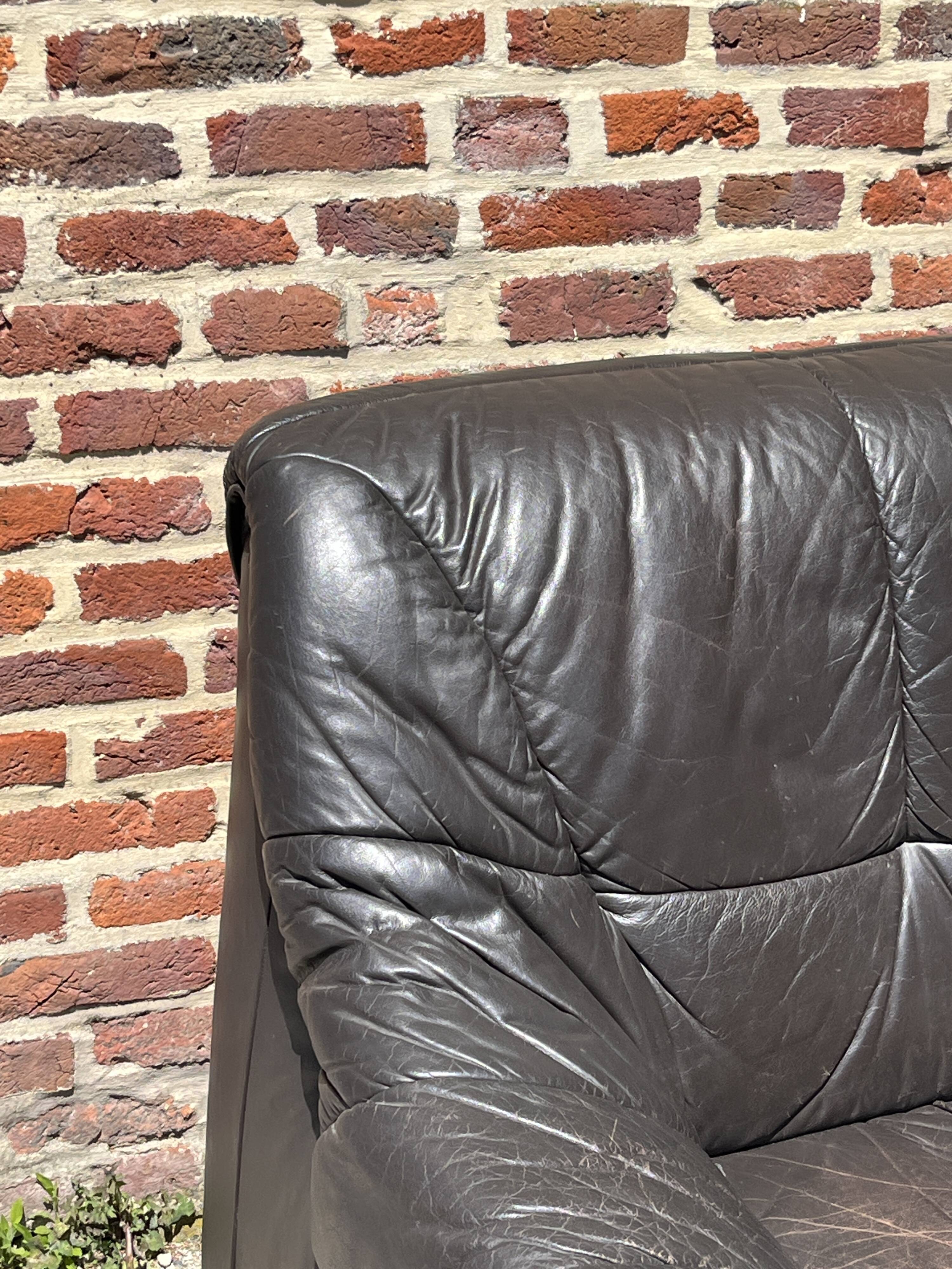 Pair of patinated leather club armchairs