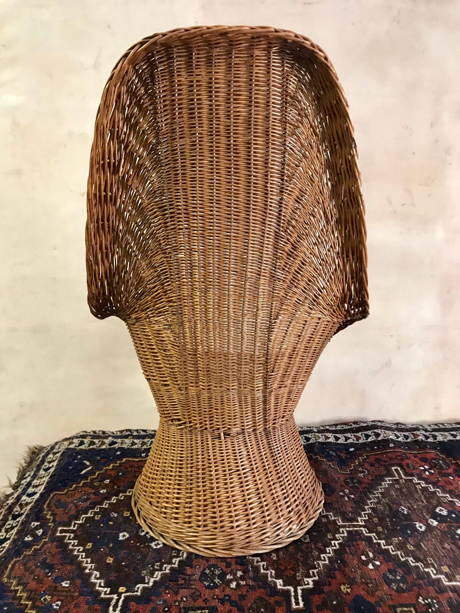 High-backed chair or shepherdess in vintage wicker