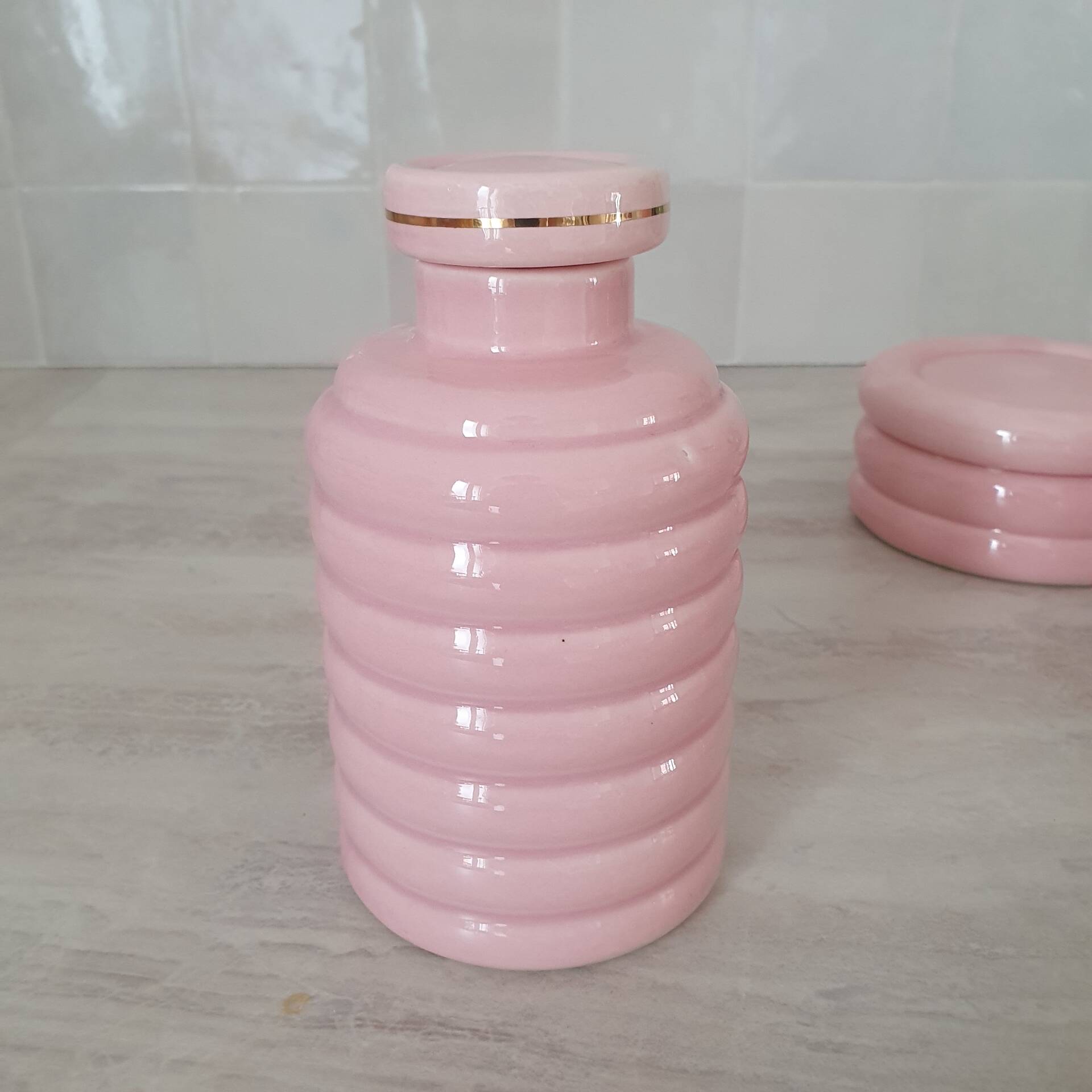 Set of pink and gold ceramic bathroom accessories