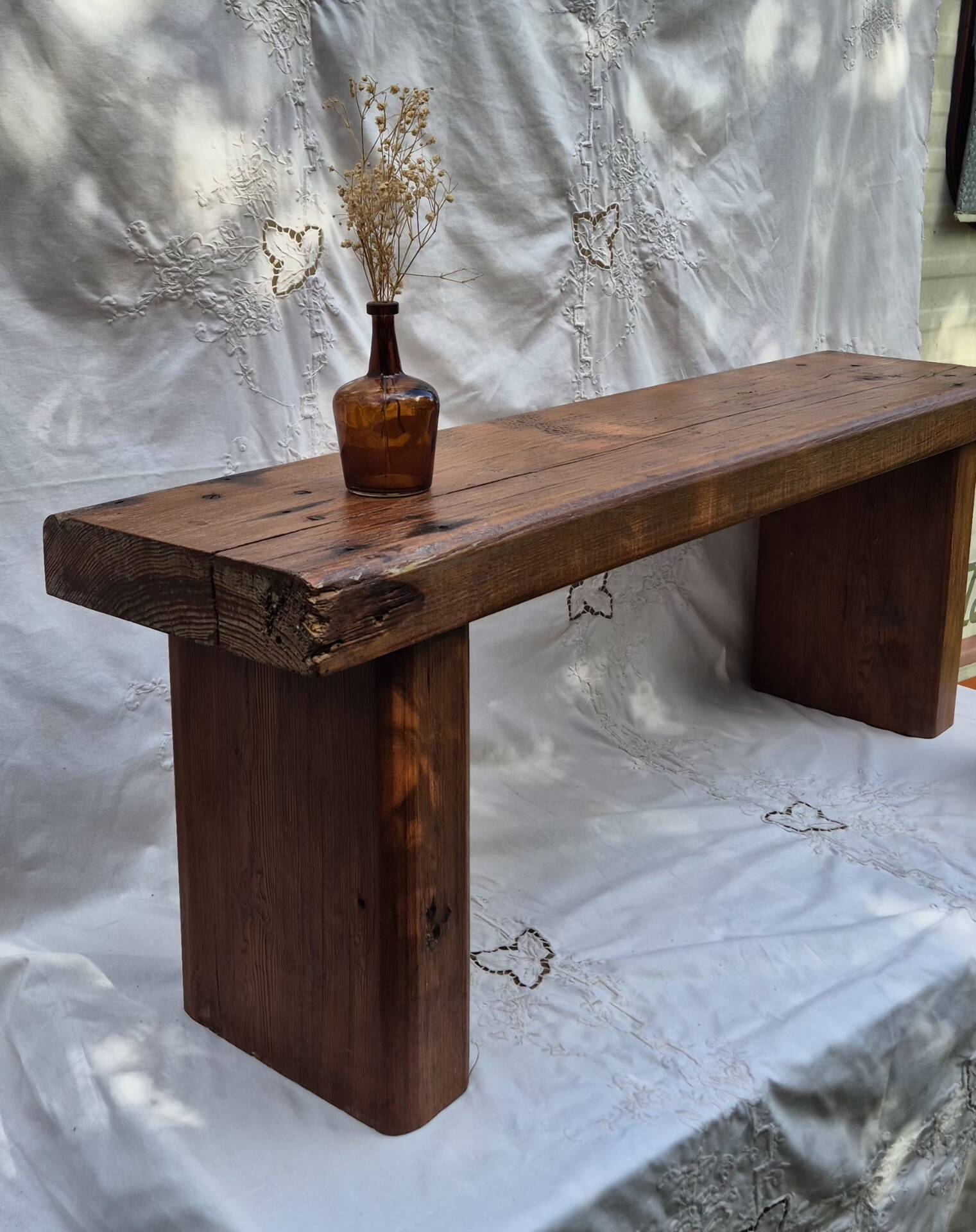 Brutalist wooden bench made of solid oak beam.