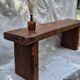 Brutalist wooden bench made of solid oak beam.