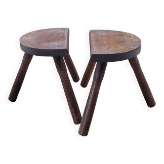 Pair of half round dark cowhide tripod stools