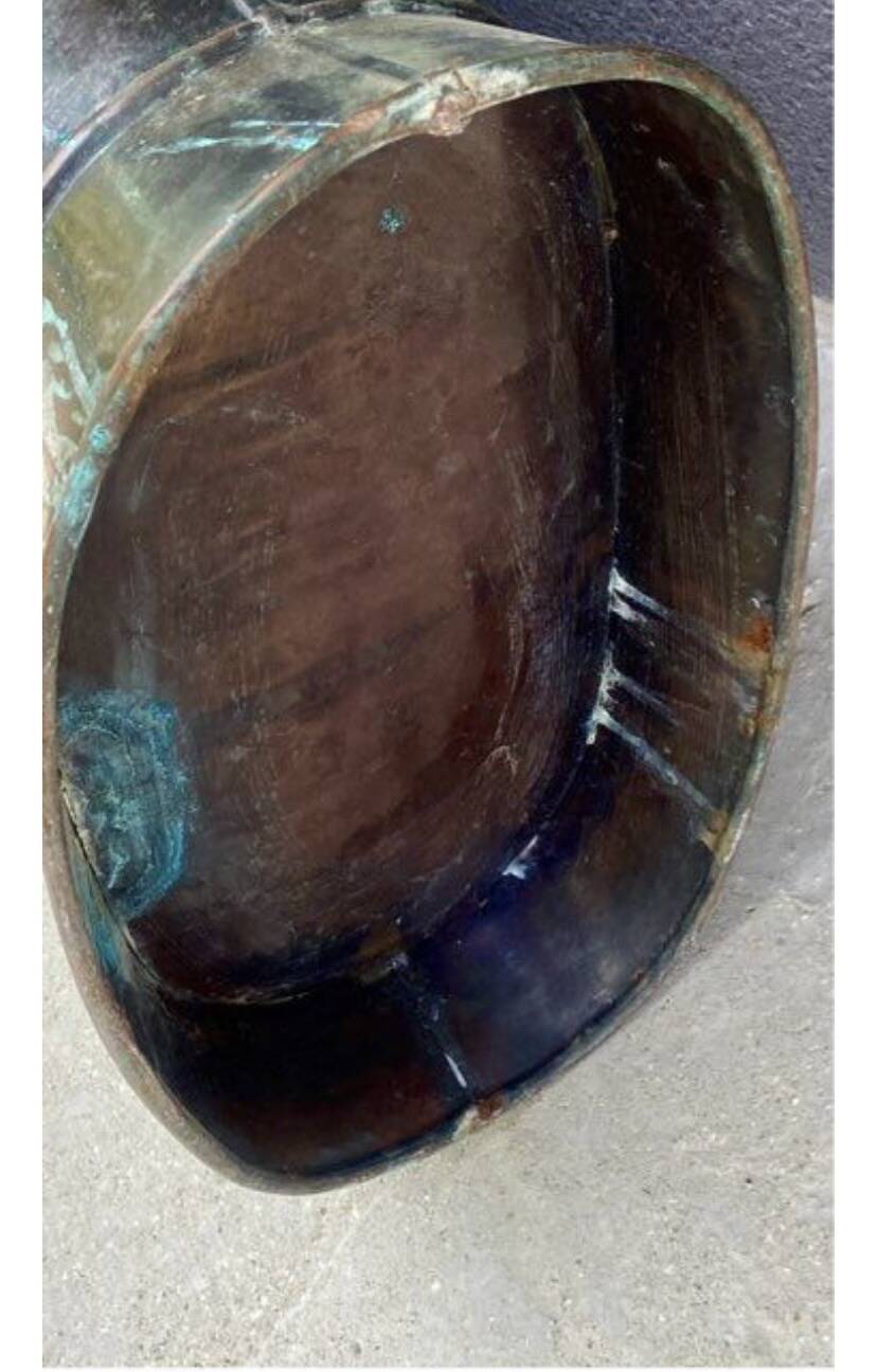 Antique red copper umbrella stand decorated with putti angels.