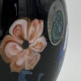 Double-lined blown glass vase with flower inclusions.