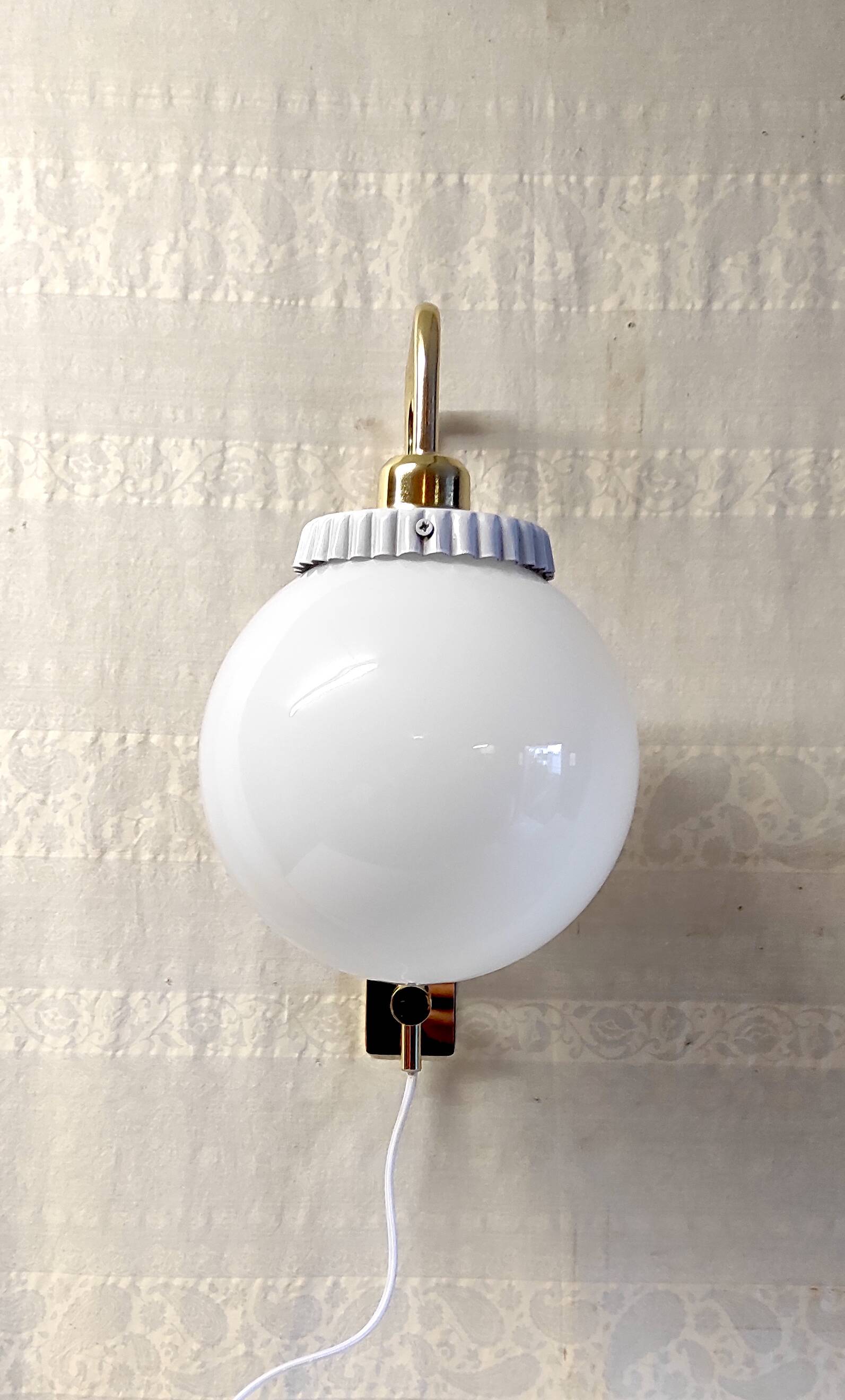 Opaline glass globe wall sconce with a gilt metal bracket - mid-20th century