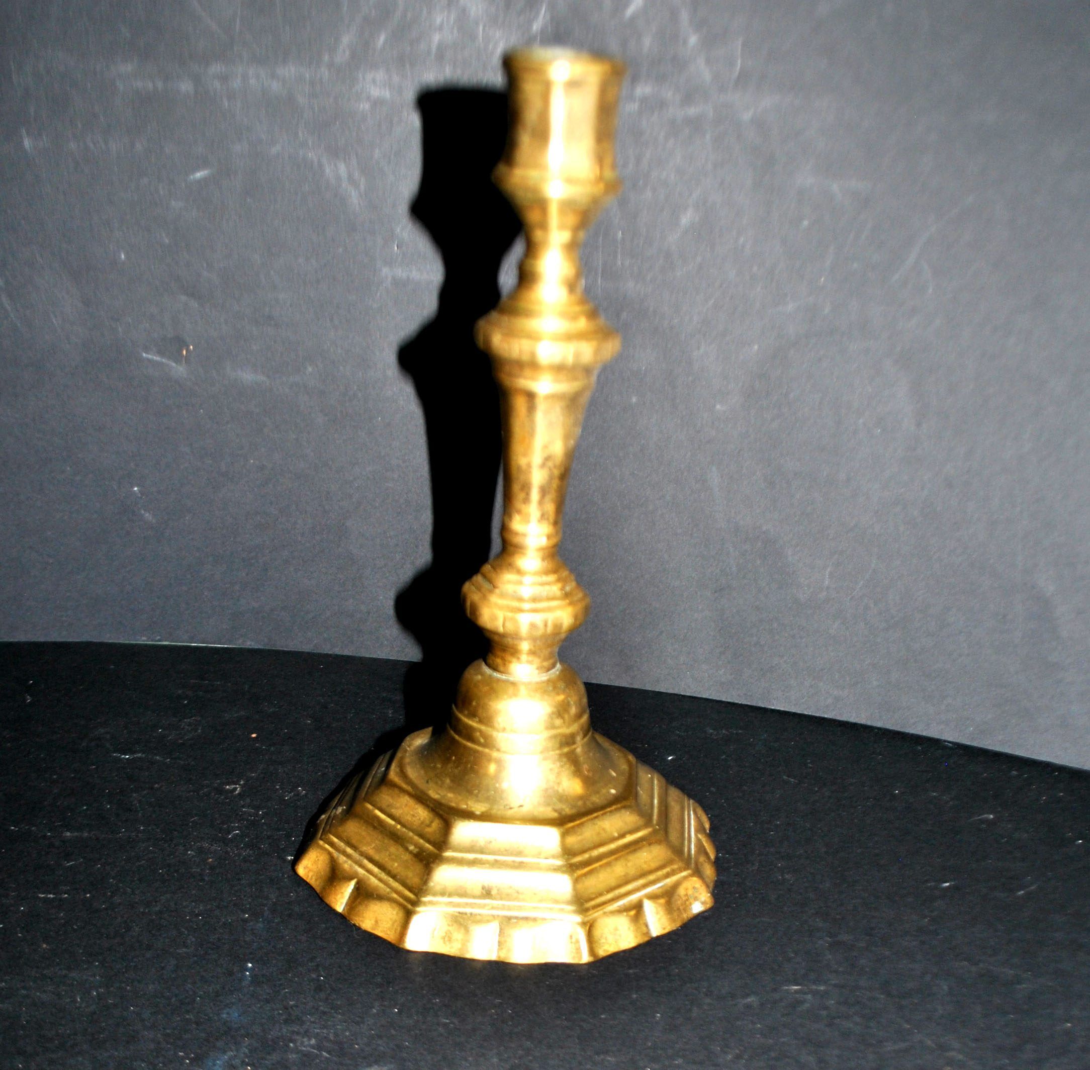 Antique 18th-century octagonal cut-out bronze candlestick in the Louis XIV style.