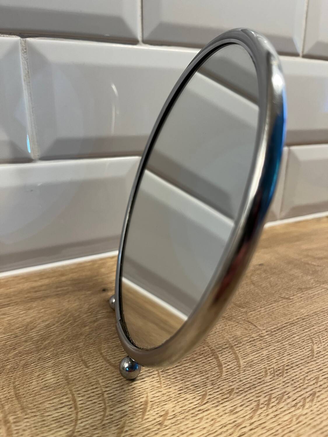 Small round barber-style mirror.