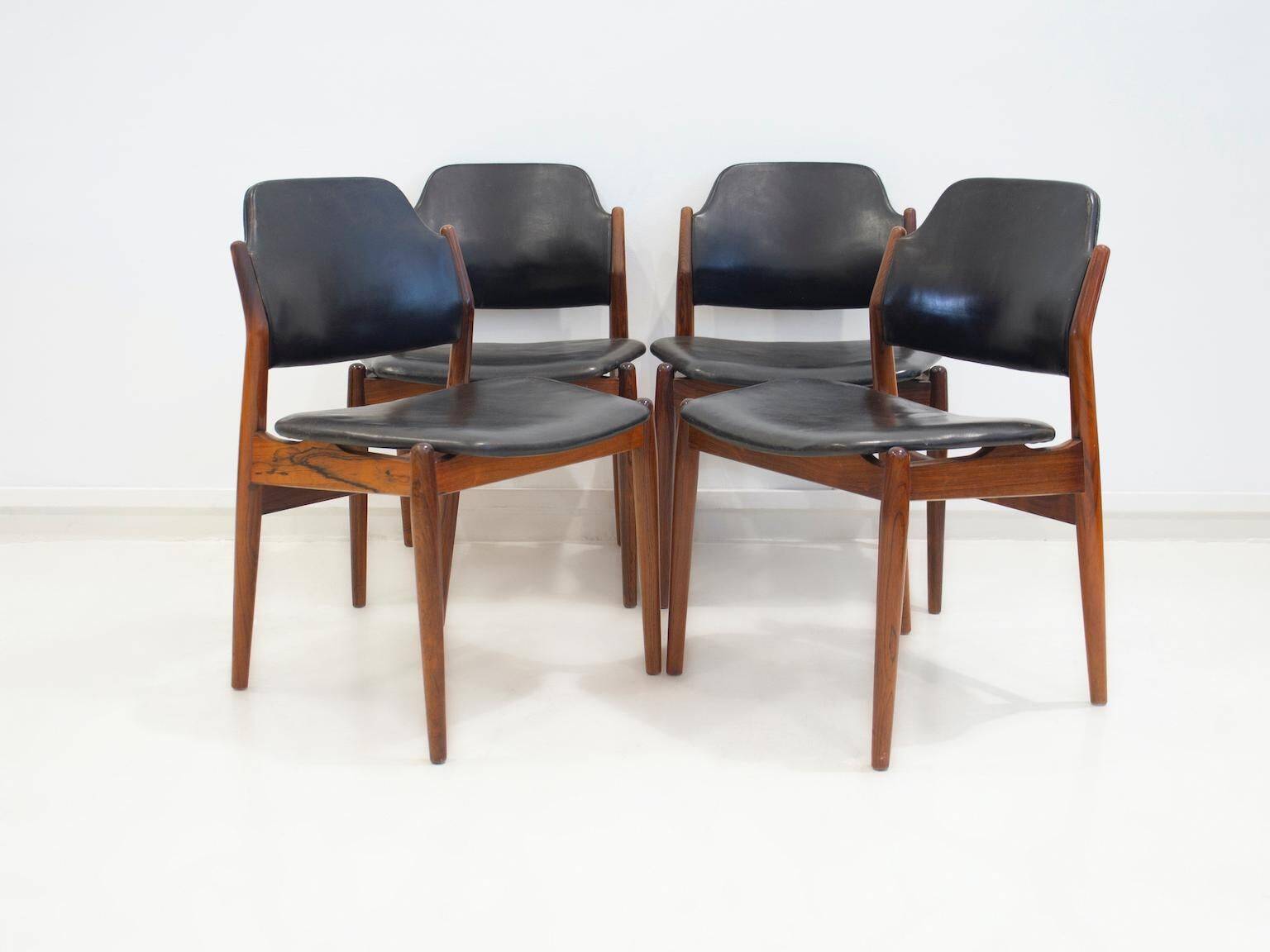 Set of four Arne Vodder chairs in hardwood and black leather.