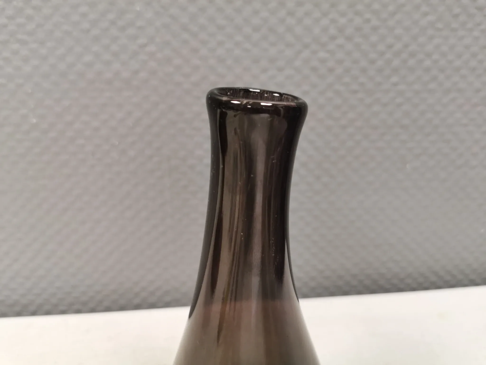 A unique vase in hand-blown glass with a hint of purple in the colour.