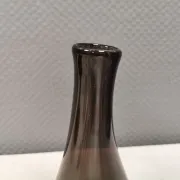 A unique vase in hand-blown glass with a hint of purple in the colour.