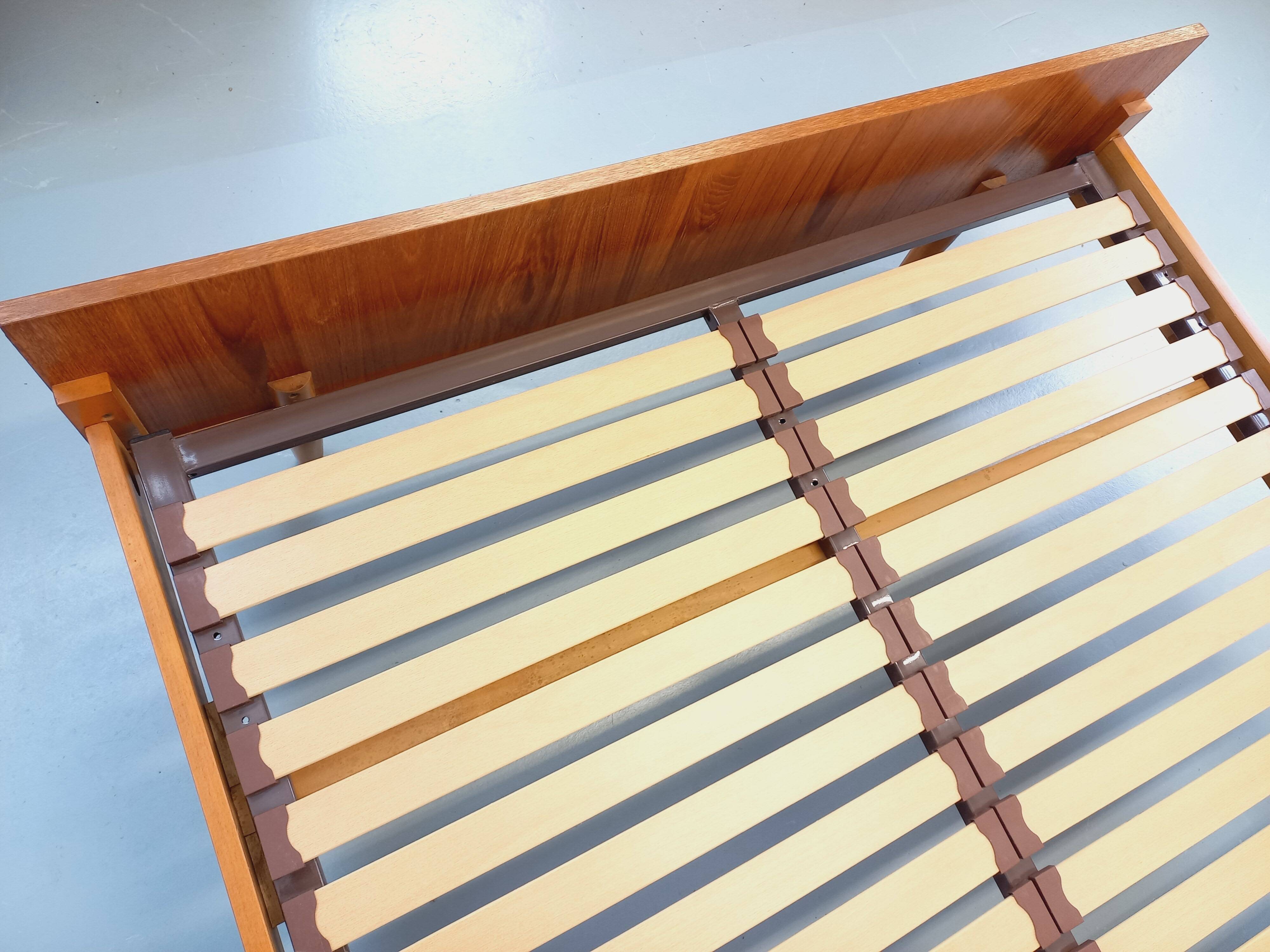 Double bed vintage Scandinavian in teak from the 1960s with integrated bedside tables.
