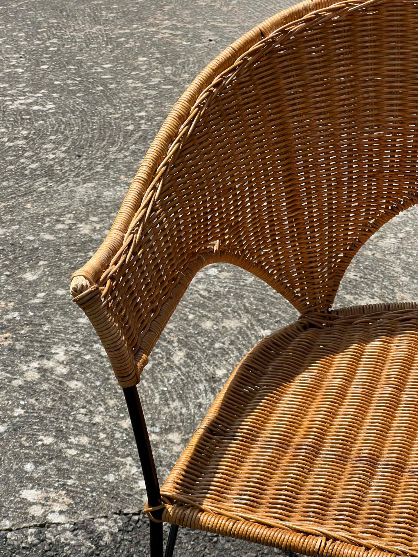 Wicker and black wrought iron armchair
