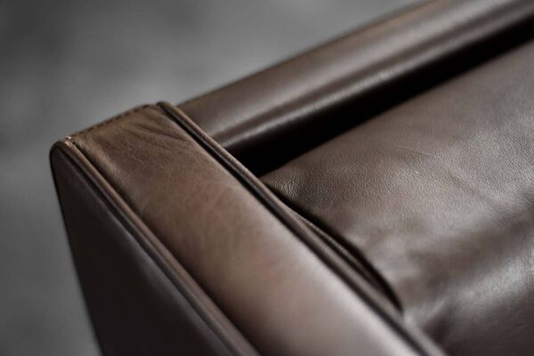 Brown leather wingback chair in mid-century modern Danish style, 1960s.