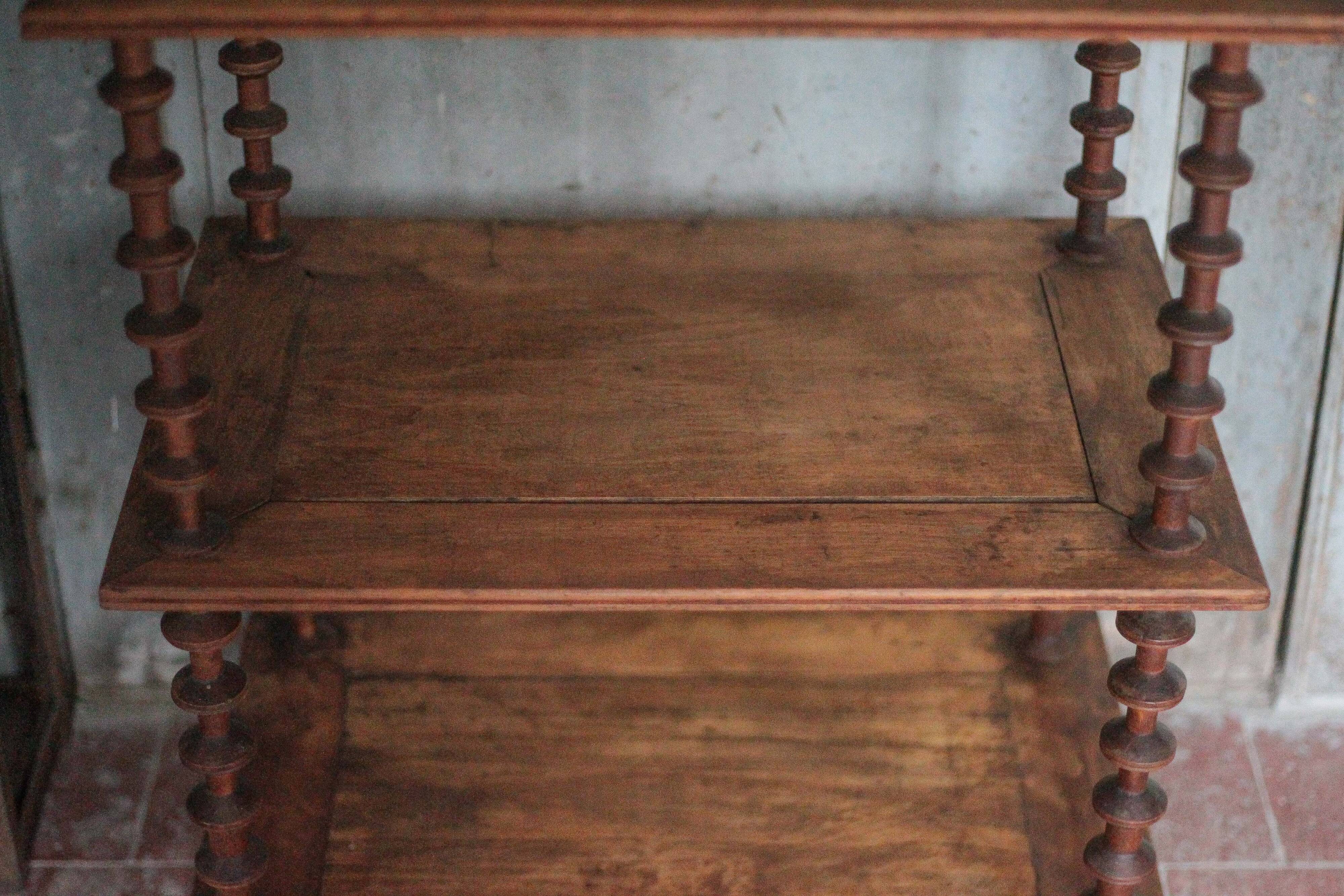 Napoleon III spool shelf, floor-standing shelf with brass tips.