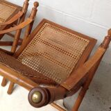 Pair of folding chairs in bamboo and caning, leather and brass