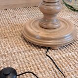 Vintage floor lamp in turned wood with aged effect.